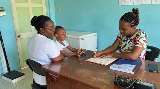 Health worker attending mother in Jamaica