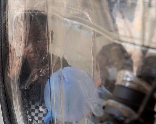 A child inside of a "CUBE" at the ALIMA Ebola Treatment Centre (ETC).